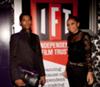 Emmanuel Ray and Karyn Louise at Independent Film Trust party.     Emmanuel Ray wears outfit by A. Hallucination. Bag by ARANGUIZ. 